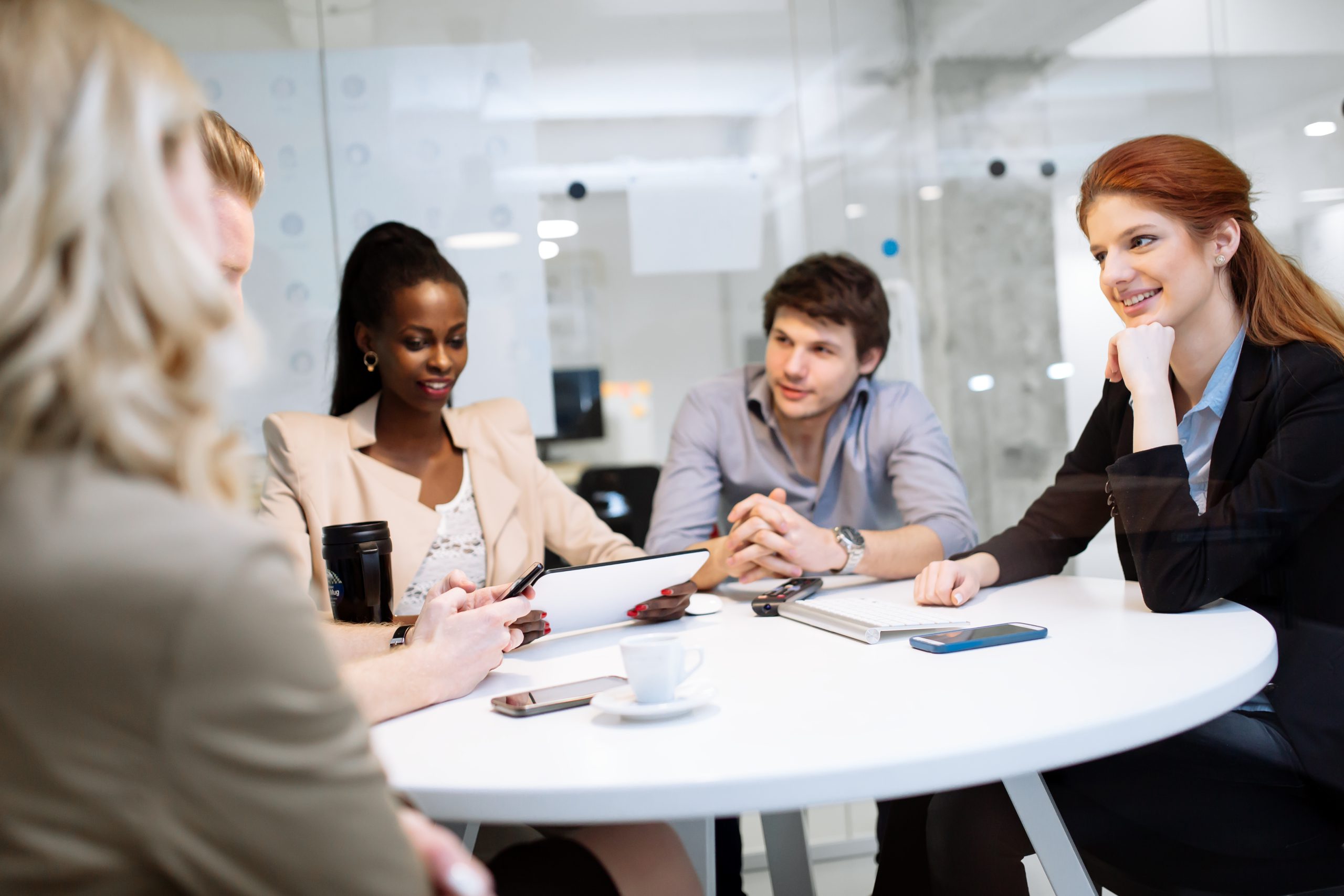 Group of business people sitting at desk and discussing new ideas